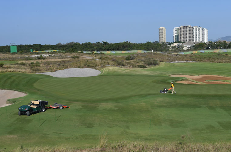 RIO DE JANEIRO, BRAZIL - AUGUST 05: A course worker mows the 17th green in preparation for the Rio 2016 Olympic Games at the Olympic Golf Course on August 5, 2016 in Rio de Janeiro, Brazil. (Photo by Chris Condon/PGA TOUR/IGF)